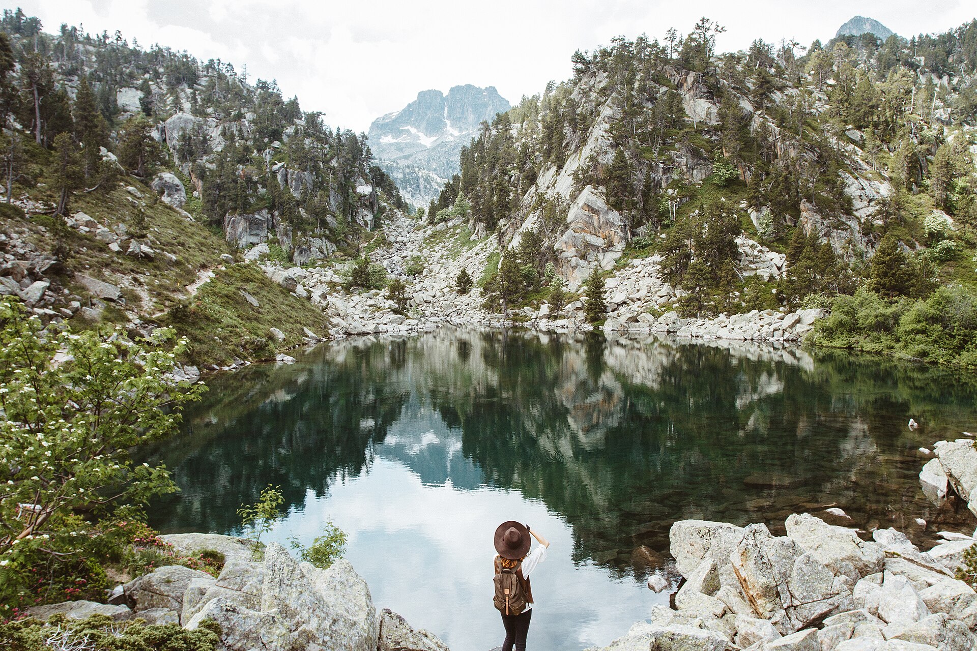 Hiker by a mountain lake in Aigüestortes National Park