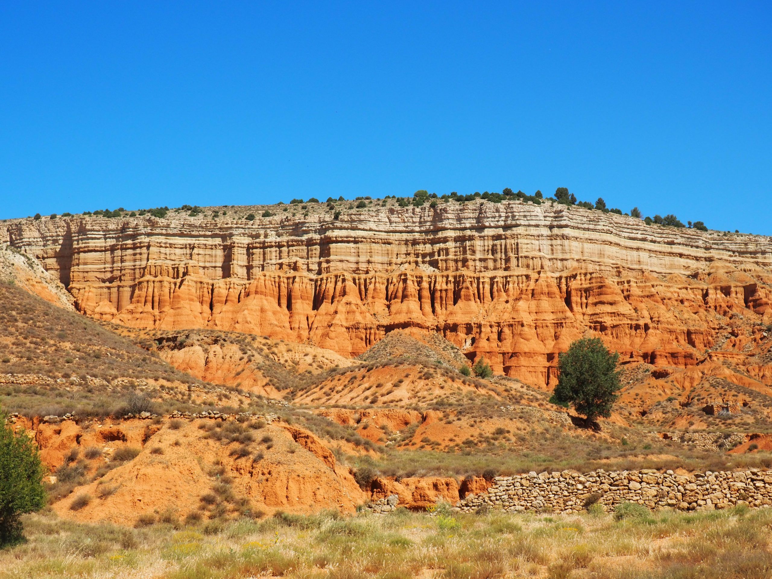 Wild West style landscape of the Red Canyon of Teruel under a blue sky