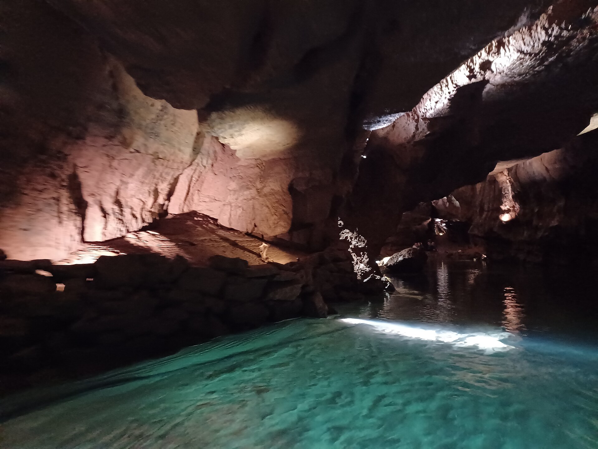 Turquoise water of the navigable underground river in the San José caves (Coves de Sant Josep)