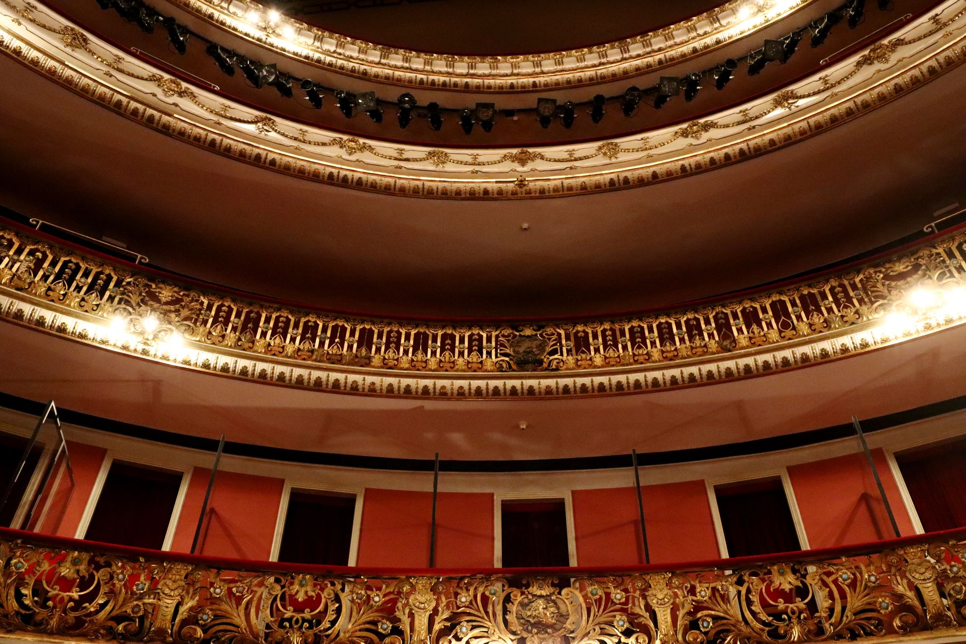 Interior de un teatro con decoración dorada e iluminación dramática