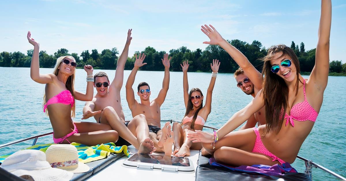 Group of international friends enjoying a catamaran boat party in Valencia